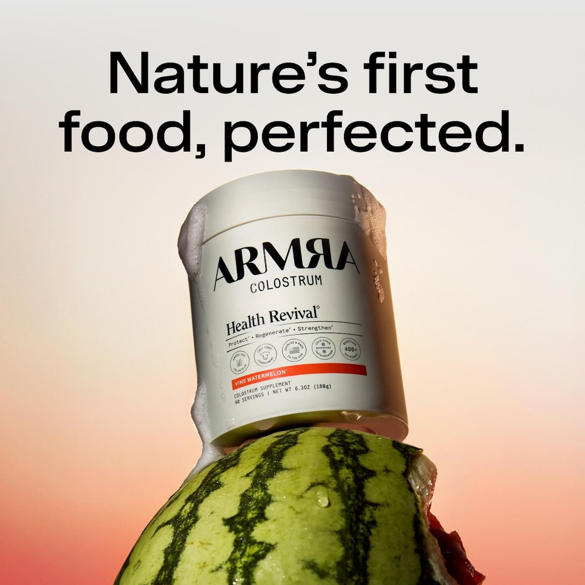 ARMRA Colostrum jar with Vine Watermelon flavor label positioned on top of a fresh watermelon against gradient background.