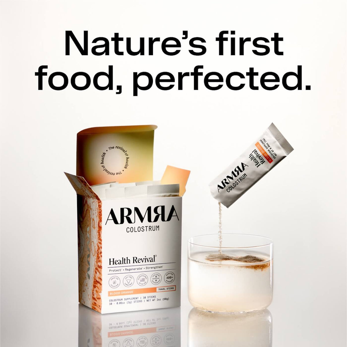 ARMRA Colostrum powder in white canister with blood orange flavor, single travel stick pouch pouring into glass of water.