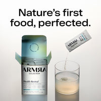 ARMRA Colostrum unflavored travel stick being poured into a glass of water.