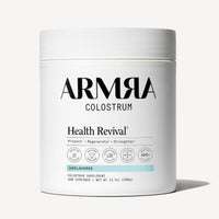 White cylindrical jar of ARMRA Colostrum powder labeled "Unflavored" with white lid and certification badges.