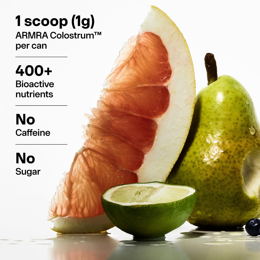 Sliced apple and pear with blueberries displayed alongside product information for ARMRA Colostrum beverage.
