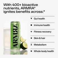 Green ARMRA colostrum soda can next to a glass of clear beverage with lime wedges.