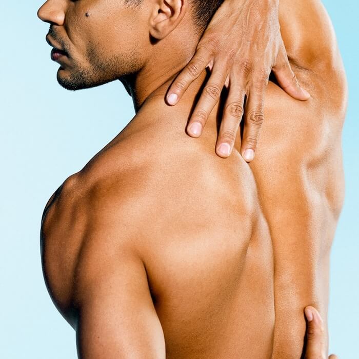Male touching his back