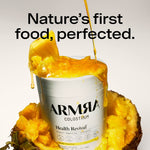 ARMRIA colostrum container with pineapple and text 'Nature's first food, perfected.'