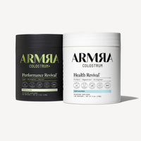 Two ARMRA Colostrum supplement containers: black Performance Revival chocolate flavor and white Health Revival unflavored var