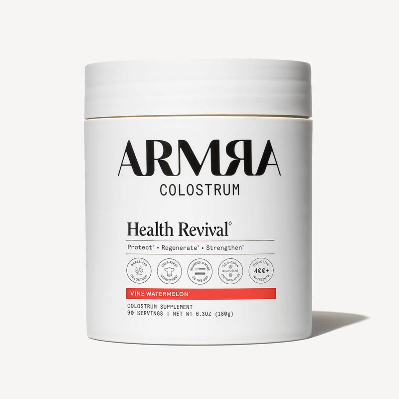 White cylindrical jar of ARMRA Colostrum with "Health Revival" and "Vine Watermelon" labeling, 6.3 oz, 90 servings.