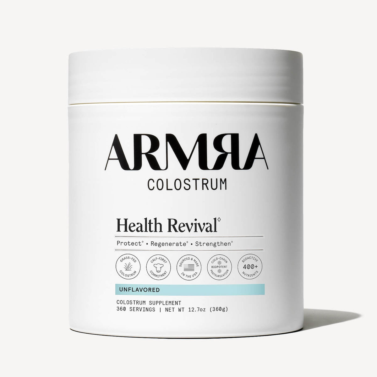 White cylindrical jar of ARMRA Colostrum powder labeled "Unflavored" with white lid and certification badges.