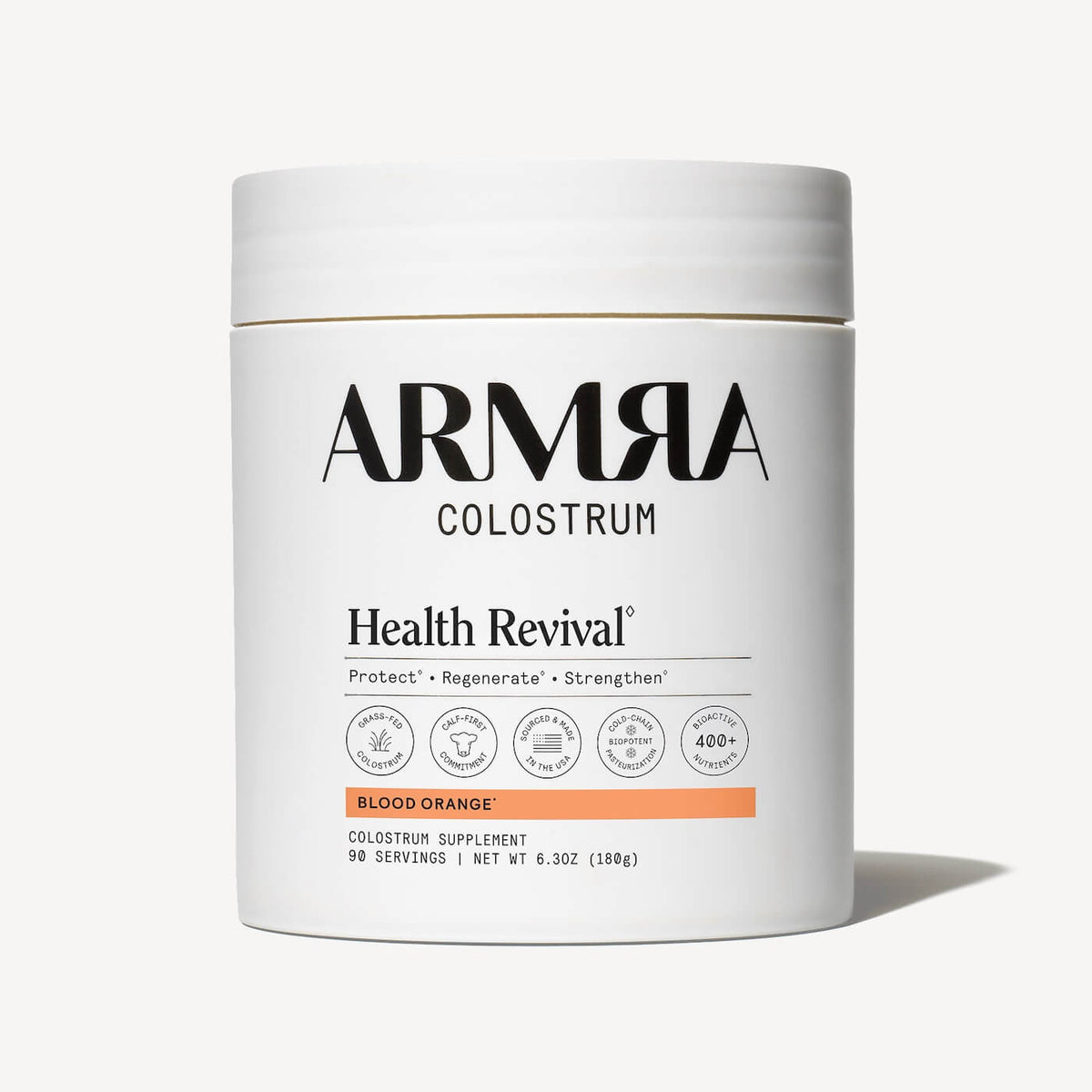 White cylindrical jar of ARMRA Colostrum powder in Blood Orange flavor, 6.3oz, with white lid and product labeling.