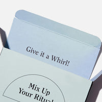 Light blue product box with rounded top edge and text reading "Give it a Whirl!" visible on the packaging.