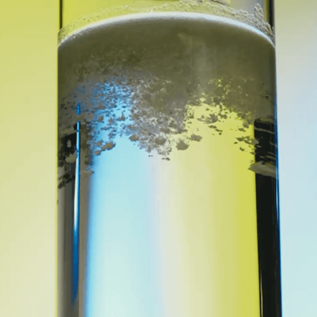 ARMRA colostrum falling into a glass of water