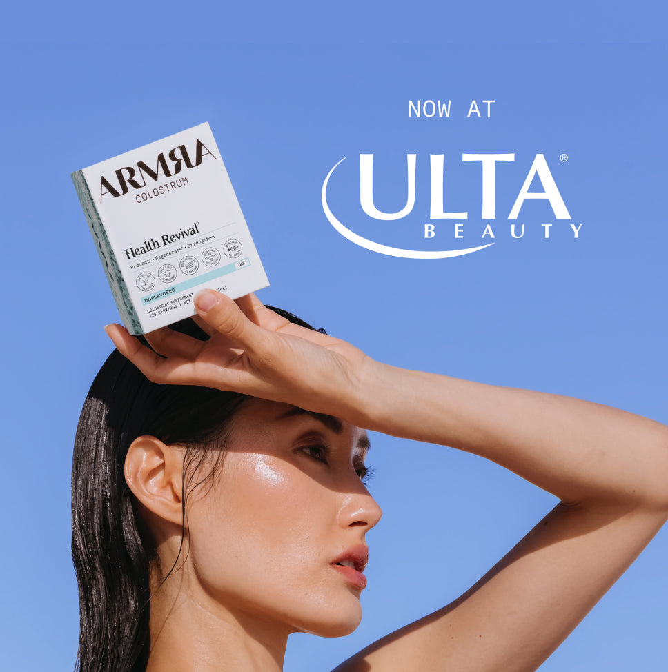 Woman holding an ARMRA product with Ulta Beauty logo on a blue background